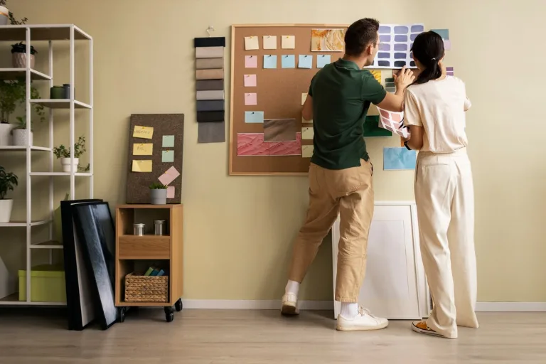 Interior designer planning a modern residential space while comparing interior design and decoration elements