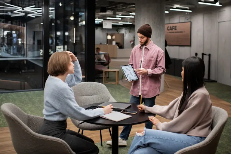 Modern coworking space with collaborative workstations, private meeting rooms, comfortable seating and natural lighting