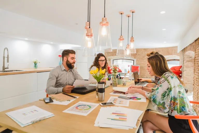 Modern office interior with quiet workstations, collaborative meeting areas, natural lighting and comfortable spaces designed to support employee focus and wellbeing.